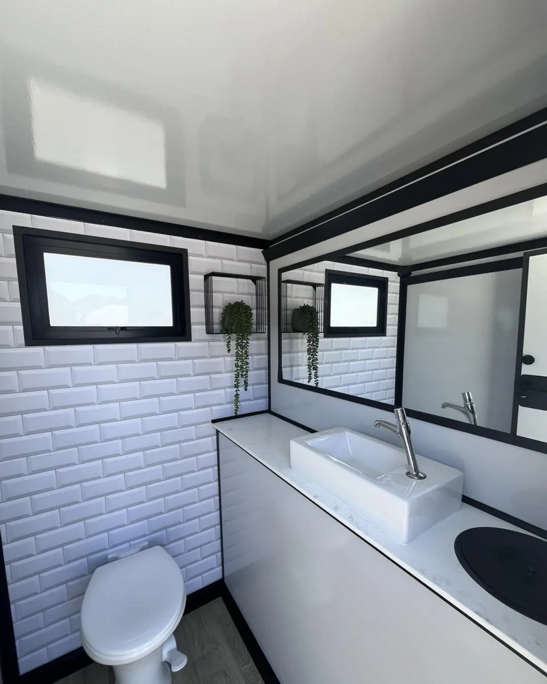 Restroom trailer vanity with sink and mirror